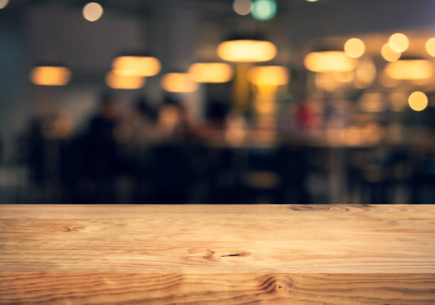 istock Wood texture table top (counter bar) with blur light gold bokeh in cafe,restaurant background.For montage product display or design key visual 1092034144