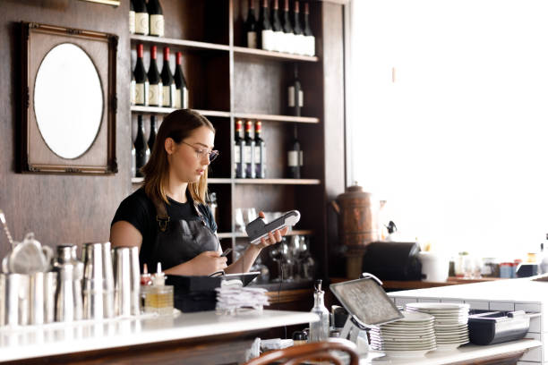 istock Female Cafe Worker Accepting Payment With Contactless POS machine 1092037234