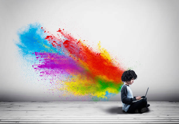 istock Young man working on laptop and a powder explosion . 1092044388