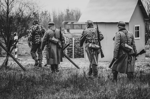 Gomel, Belarus - November 26, 2017: German soldiers guard germanium Wehrmacht World War II come to the checkpoint. Black and white image photo