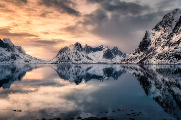 istock Snow mountain reflection on arctic seashore at sunset 1092049926