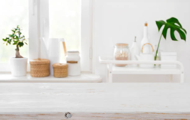 istock Wooden table on blurred background of kitchen window with utensils 1092064144