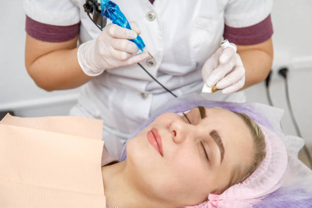 istock Permanent makeup, tattooing of eyebrows. Cosmetologist applying make up 1092072356