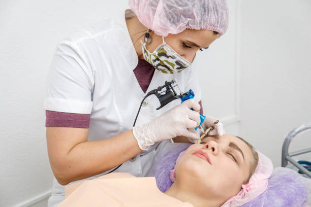 istock Permanent makeup, tattooing of eyebrows. Cosmetologist applying make up 1092072392