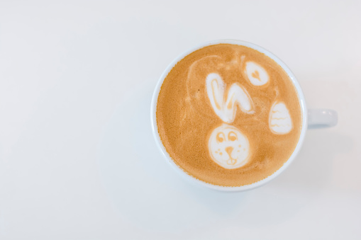 Cafe latte easter bunny latte art on white table