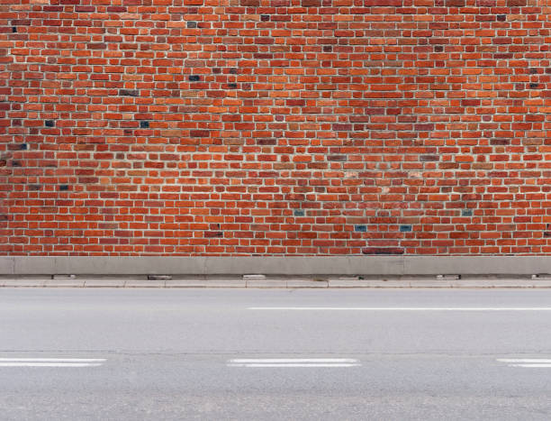 istock Citty traffic asphalt empty road with sidewalk and three lane for traffic and brick wall 1092078086