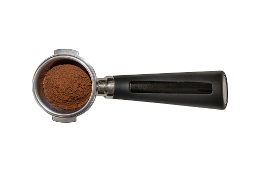 Coffee barista scoop or spoon machine full of ground coffee isolated