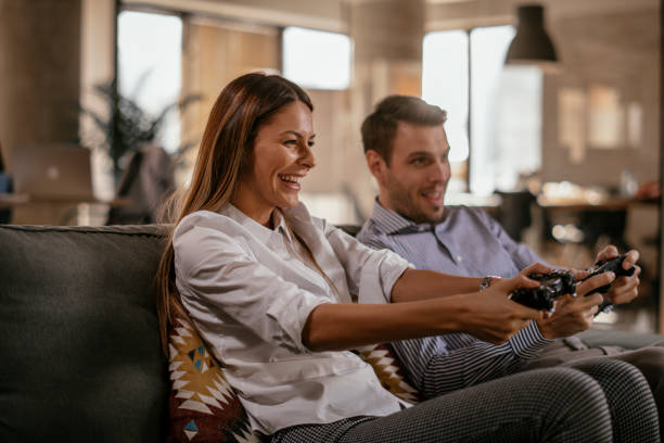 istock Happy couple playing video games 1092081668