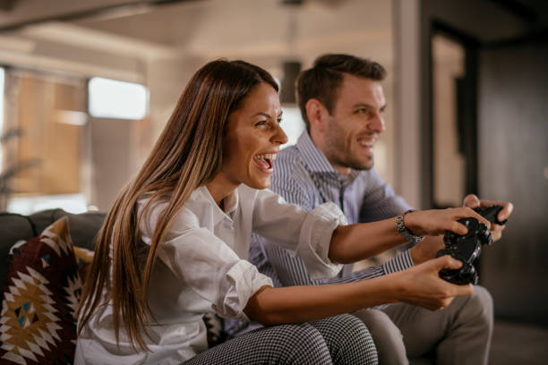 istock Happy couple playing video games 1092082976