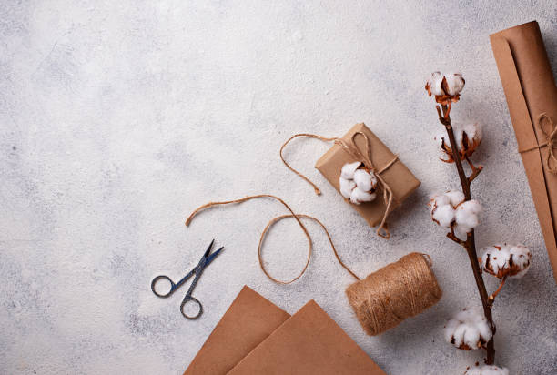 istock Process of packing gifts boxes in craft paper. 1092083858
