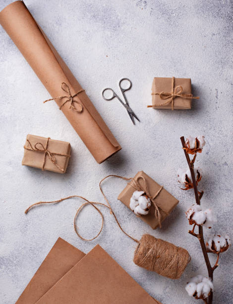 istock Process of packing gifts boxes in craft paper. 1092083924