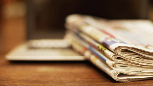 istock Newspapers and laptop 1092089446