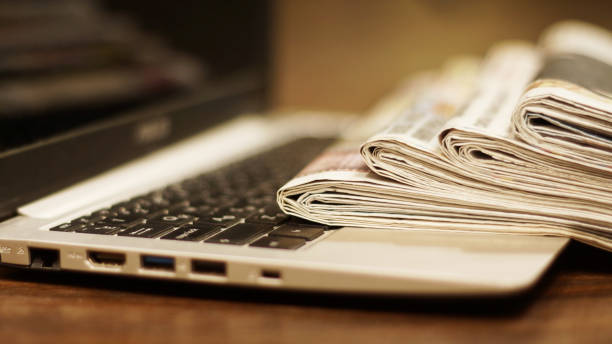 istock Newspapers and laptop 1092089520