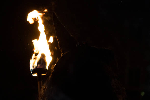 istock witch in the black holding a torch 1092089920