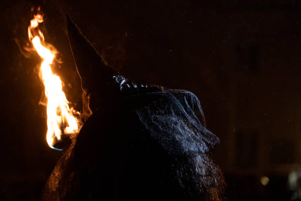 istock witch in the black holding a torch 1092090050