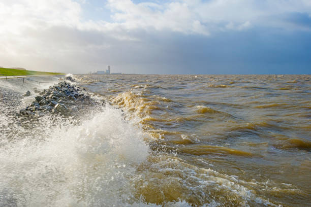 istock Dike along a stormy lake in sunlight in winter 1092091870