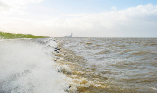 istock Dike along a stormy lake in sunlight in winter 1092091940