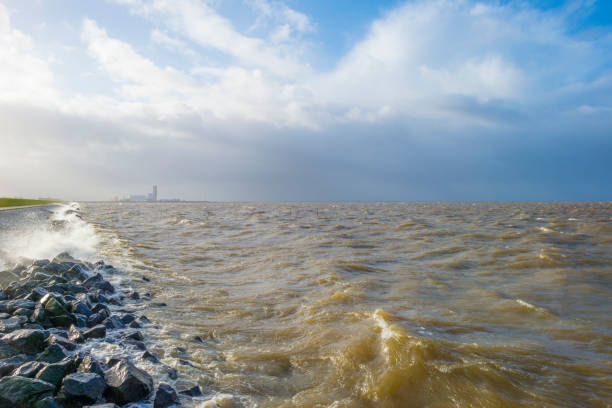 istock Dike along a stormy lake in sunlight in winter 1092091944