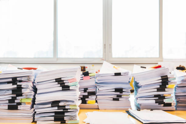 istock Pile of unfinished documents on office desk. 1092091986