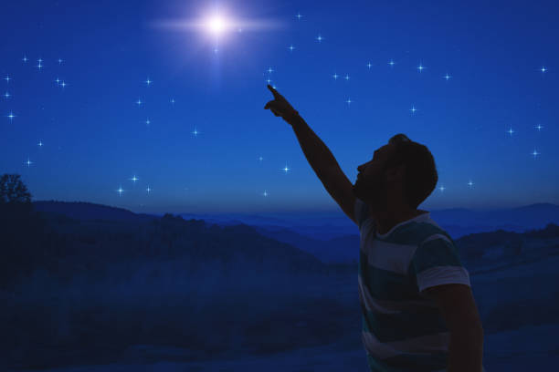 istock Man pointing at the starry night sky. Elements of this image are my work. 1092095622