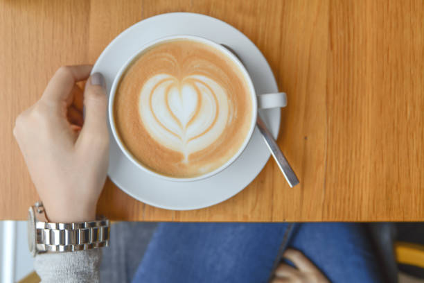 istock Girl in cafeteria with big cup cafe latte on table for morning break 1092095914