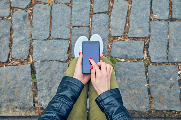 istock Woman sitting on a bench and using smartphone. 1092096076