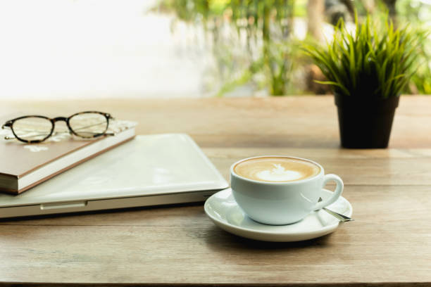 istock Coffee cup with laptop computer and glasses on wooden table. 1092096284