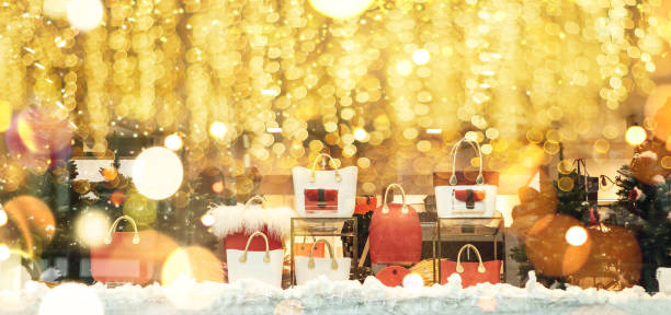 Shop window decorated in Christmas style. Christmas and New Year sales. Many different handbags and other items are sold in stores.