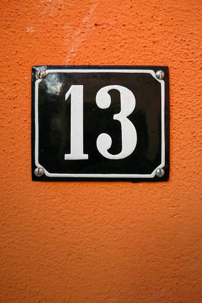 istock the number thirteen on an orange wall 1092100792