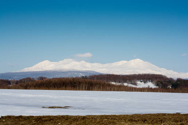 istock Spring snowy field and mountains.Mt.Daisetuzan 1092101096