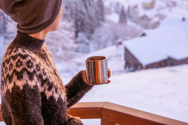 istock Young woman drinking tea or coffee with nature on background 1092102802