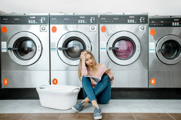 istock Woman in the self-service laundry 1092104088