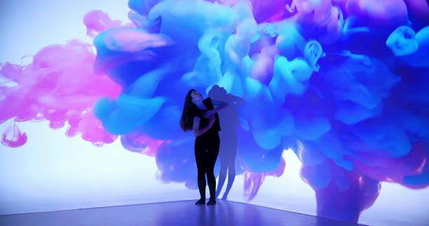 Colored ink projection upon a female dancer