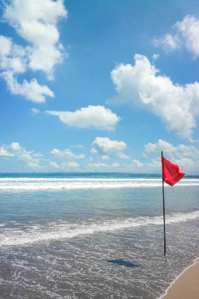 istock a beach at Bali with a red flag 1092107362