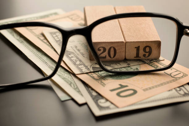 istock Glasses, number 2019 on the dollar banknotes background 1092109998