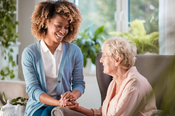 istock Cheerful nurse consoling an eldery lady 1092110924