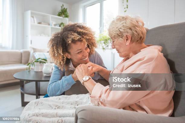 Cheerful Nurse Taking Care Of Eldery Lady Stock Photo - Download Image Now - Alzheimer's Disease, Happiness, African-American Ethnicity