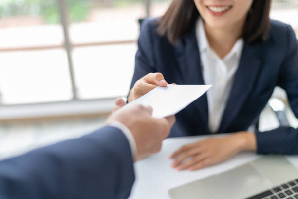 Young Asian business woman receiving salary or bonus money from boss or manager at office happily. Young Asian business woman receiving salary or bonus money from boss or manager at office happily. refund stock pictures, royalty-free photos & images