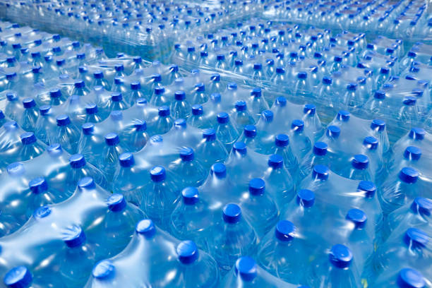 istock Many packaged blue mineral water bottles in stock 1092112820