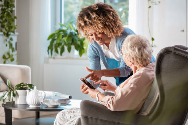 Friendly nurse supporting of senior woman
