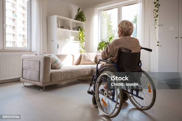 Lonely Senior Woman Sitting In Wheelchair In Her House Stock Photo - Download Image Now