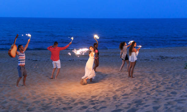 istock Friends with fireworks running on beach 1092116404