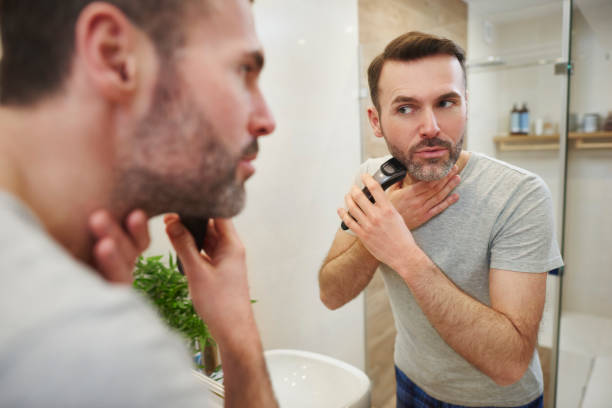 istock Man with electric razor shaving 1092118200