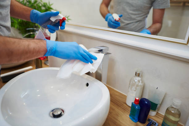 istock Man's hands cleaning sink in the bathroom 1092118376