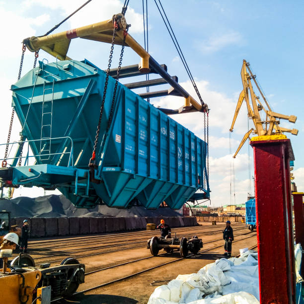 Raising the hopper car for unloading on a cargo ship. Lifting operations in the port. Novorossiysk, Russia - October 10, 2017: Wagon of the hopper for unloading on a cargo ship. Lifting operations in the port. krasnodar krai stock pictures, royalty-free photos & images