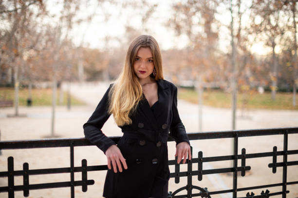 istock Pretty model woman posing in a park resting on a fence 1092128204