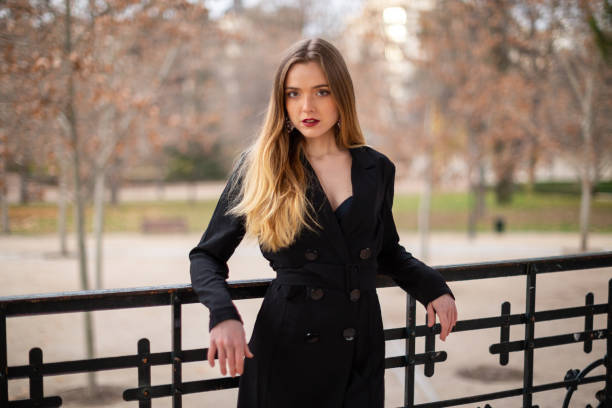 istock Pretty model woman posing in a park resting on a fence 1092128214
