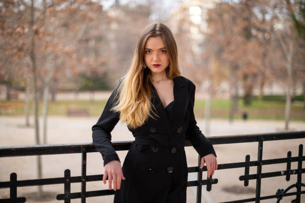 istock Pretty model woman posing in a park resting on a fence 1092128268