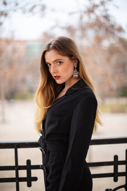 istock Pretty model woman posing in a park resting on a fence 1092128418