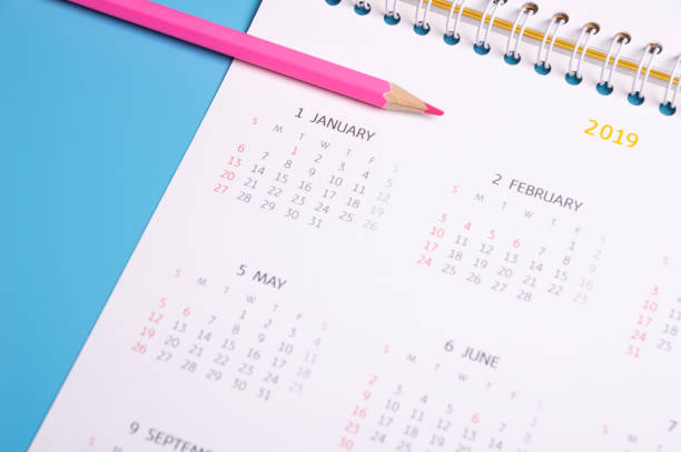 istock red pencil and calendar on blue background 1092128508